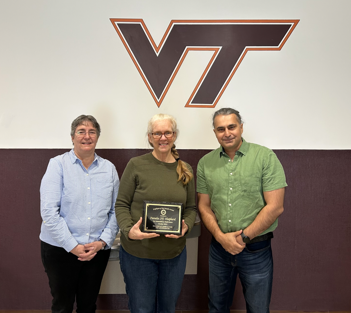 CALS employee of the month, Pamela "PJ" Shepherd, receiving plaque