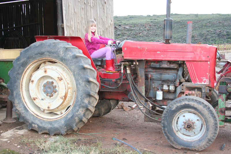 Tessa on a tractor as a child