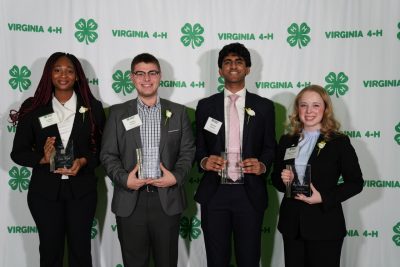Four 4-H youth members pose with their awards