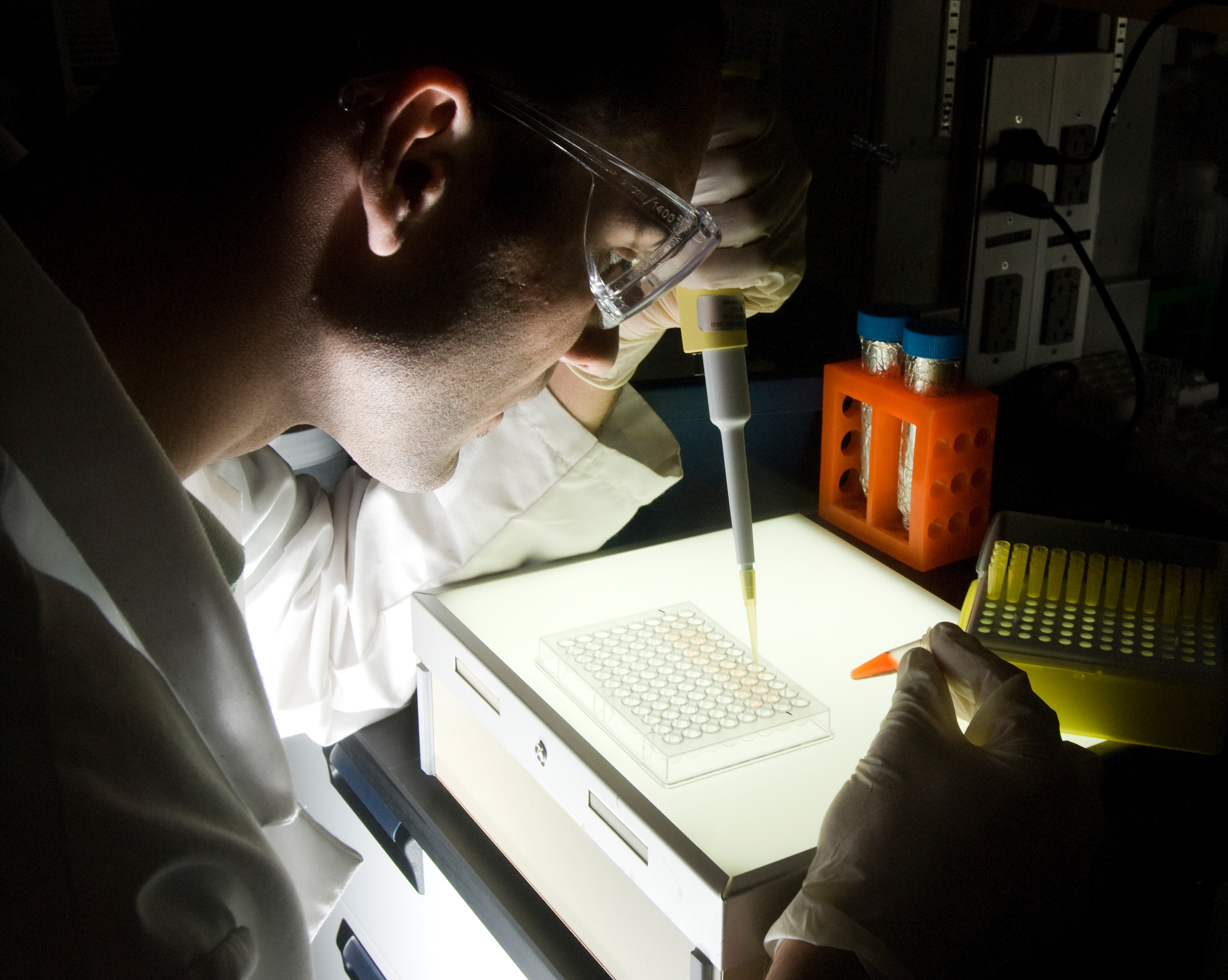 Man with pipette in a lab