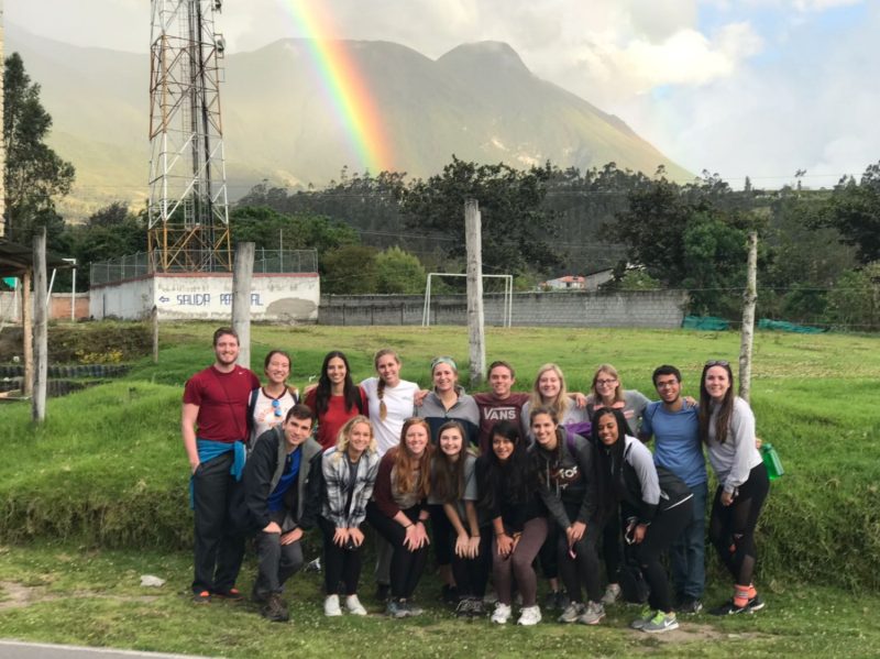 Group photo in front of a rainbow after learning about traditional indigenous music and culture.